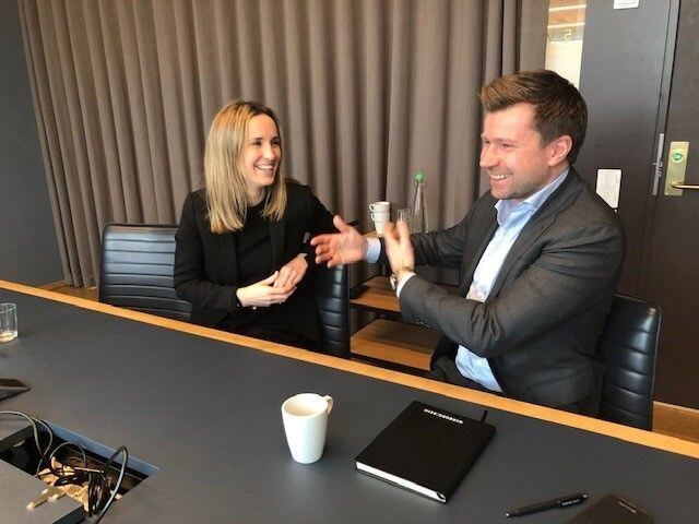Two people engaged in conversation and laughing together