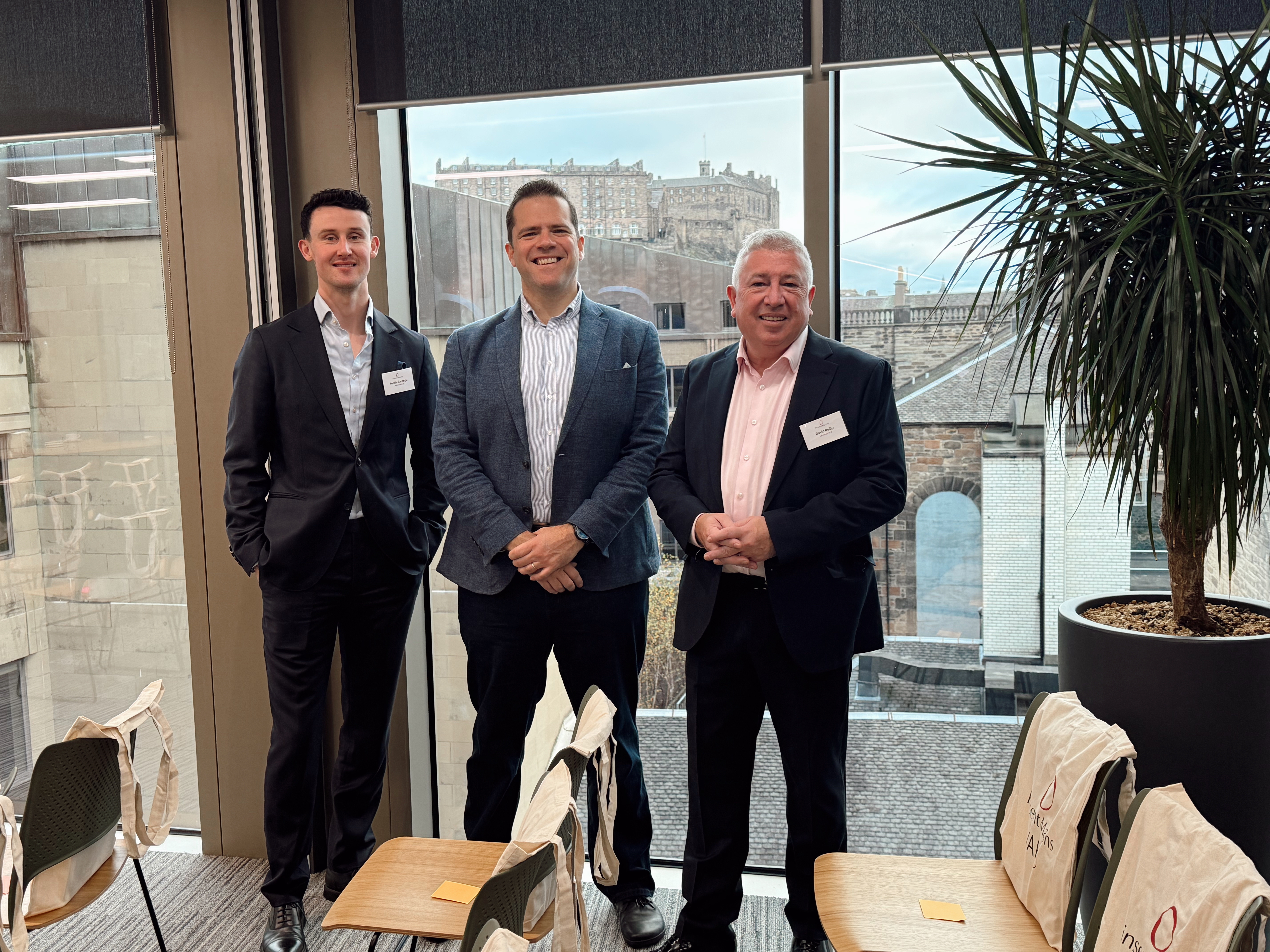 Two colleagues look at a computer screen together 